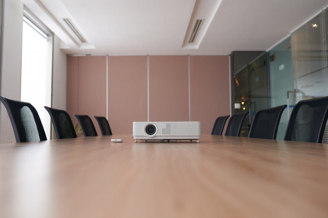 Pan Shot Empty Office With Projector Middle Conference Desk_1098